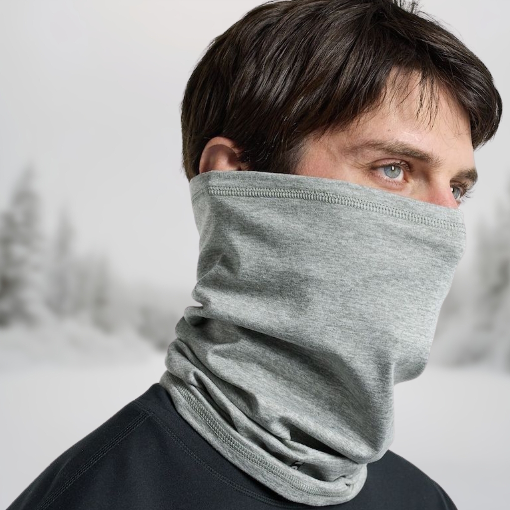 A person wearing a light gray neck warmer balaclava that covers the lower face and neck, with only the eyes visible.