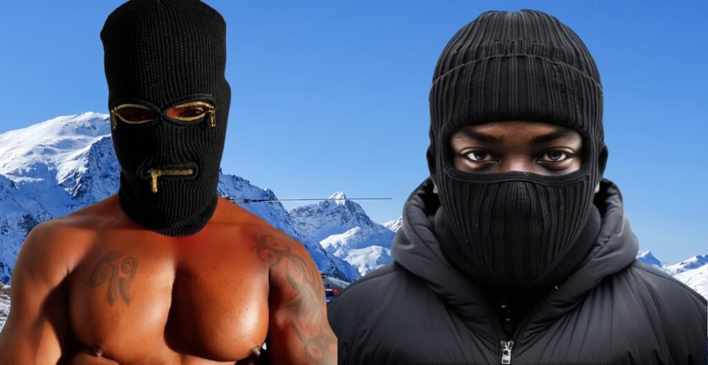 Black woman posing in a pink ski mask with hoop earrings and bold makeup, showcasing streetwear style.