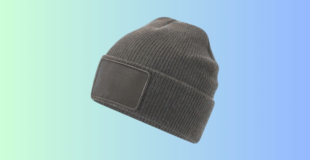 Gray knit beanie with a rectangular fabric patch sewn on the front