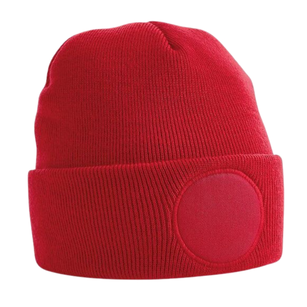 Red knit beanie with a folded cuff and a round fabric patch on the front