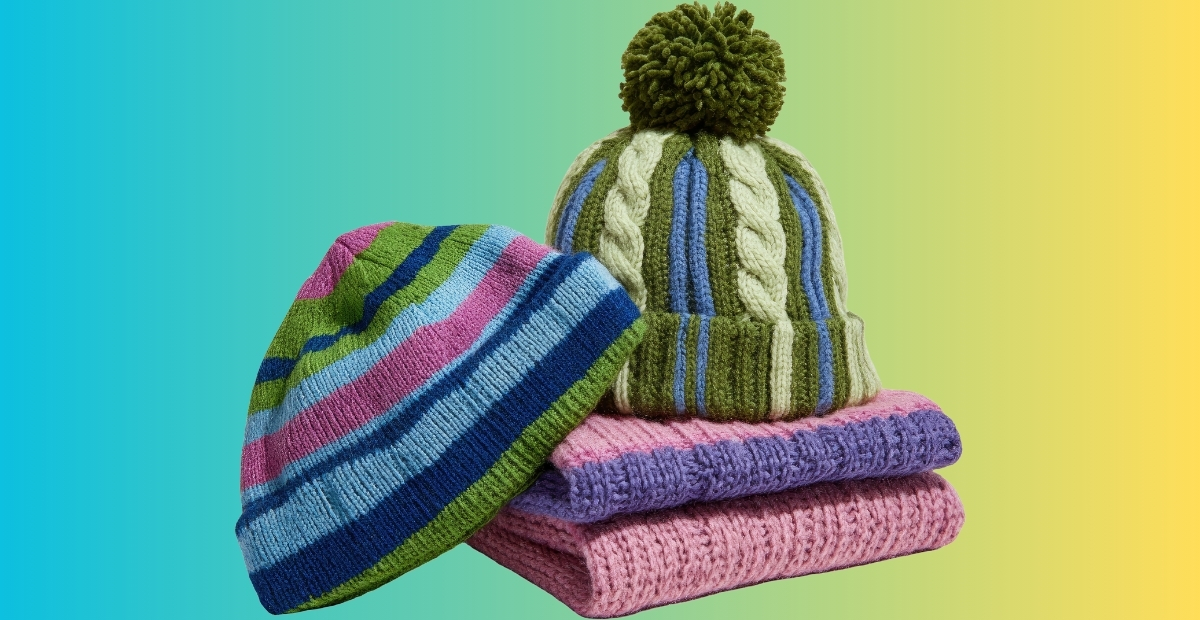 A stack of colorful knit beanies in shades of blue, green, pink, and purple against a gradient background.