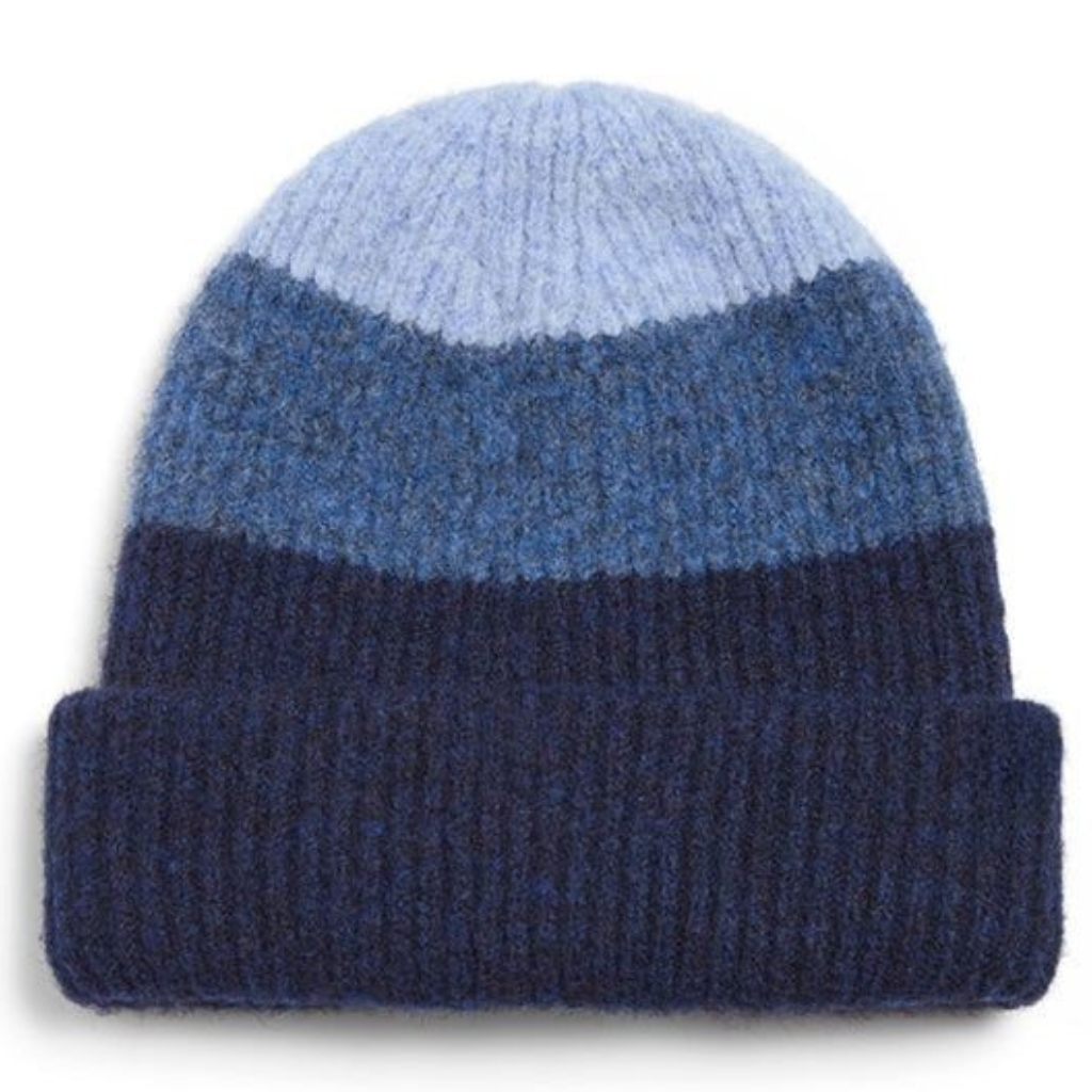 Color-block beanie featuring contrasting knit panels for a bold, modern winter look.