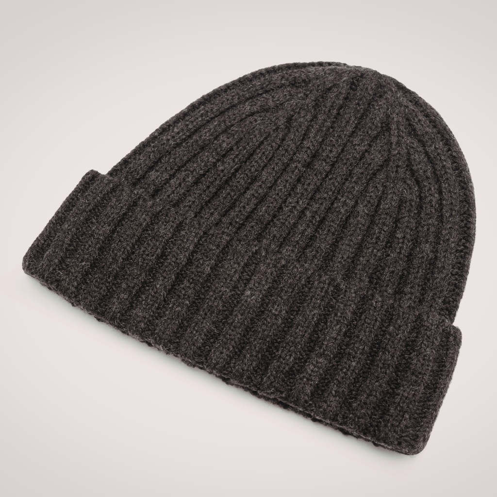 A dark charcoal gray ribbed knit beanie hat laid flat on a light background.