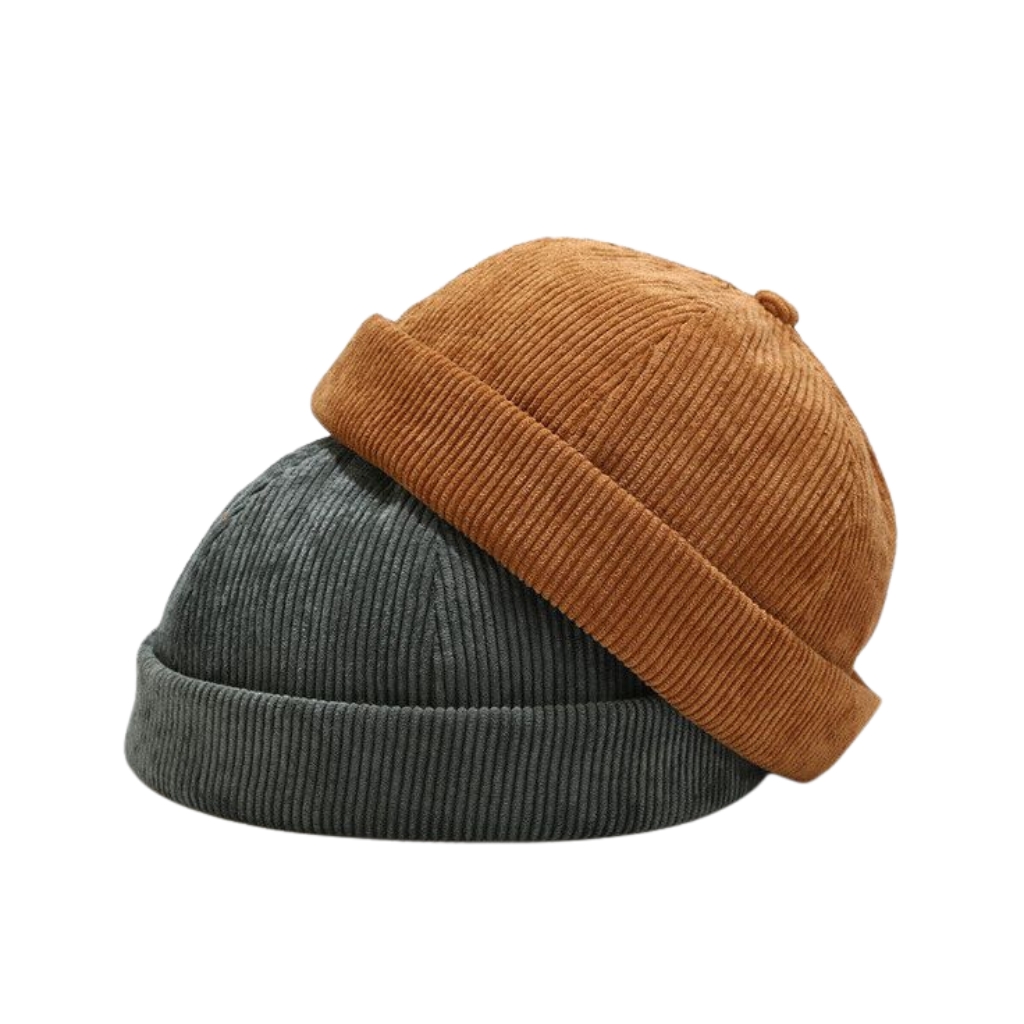 Two tone corduroy beanies stacked together: a dark gray beanie underneath and a brown beanie folded over on top, against a white background