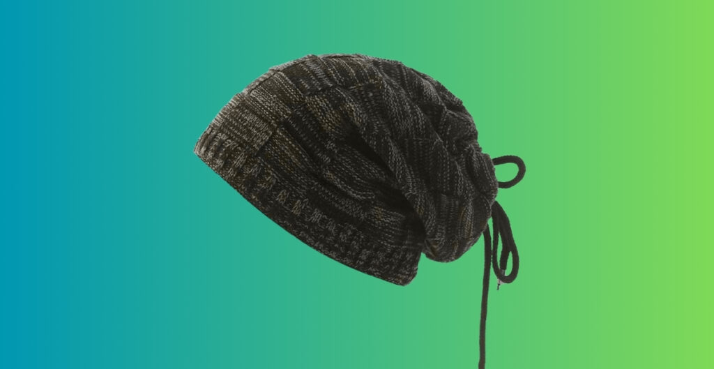 Dark knit drawstring beanie with a tied cord on the side, suspended against a blue-to-green gradient background.