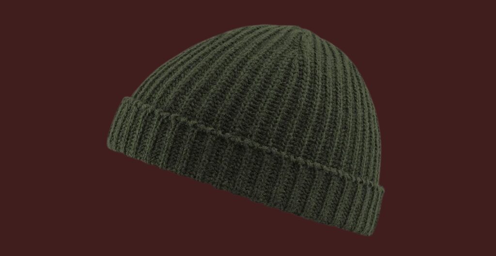 A dark green ribbed fisherman beanie displayed against a maroon background