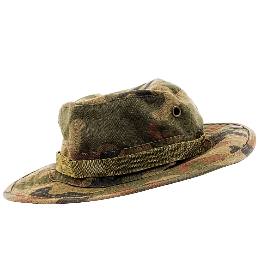 "Camouflage boonie hat with a chin strap and metal eyelet, in woodland camouflage pattern."

