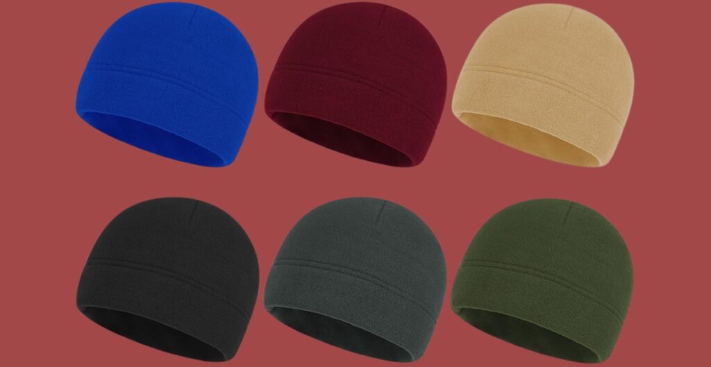 Six colorful skullcap beanies arranged on a reddish-brown background (blue, burgundy, beige, black, charcoal, and olive