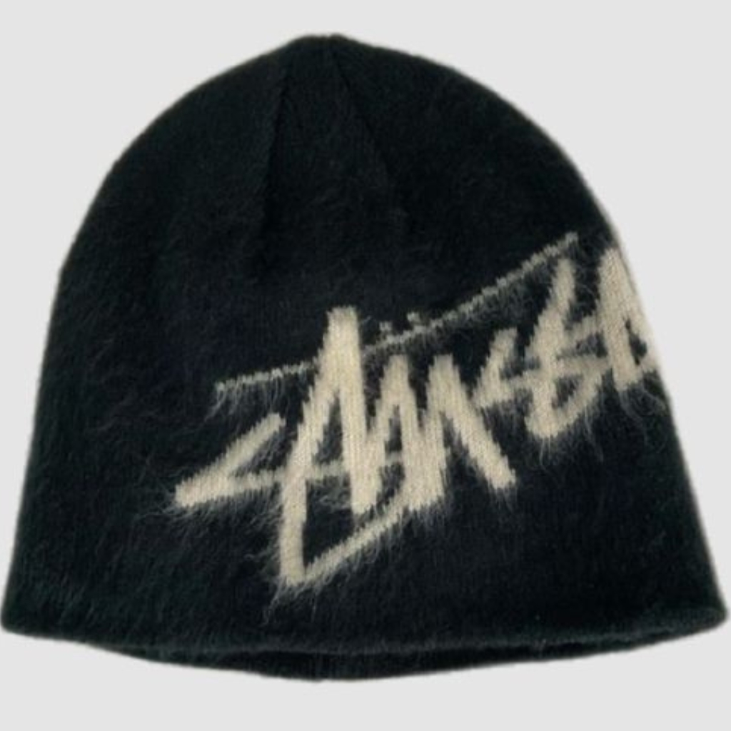 A black knit beanie with a white embroidered logo or wordmark diagonally across the front.