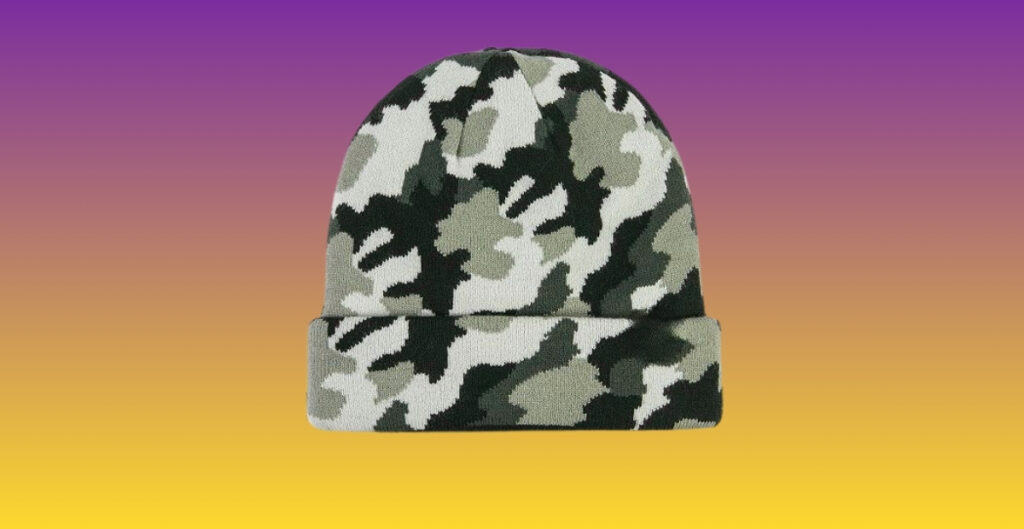 Camo-patterned beanie hat in green, gray, and black tones shown against a purple-to-yellow gradient background.