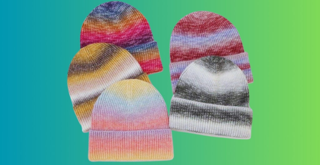 Five knit beanies with tie-dye patterns in a variety of colors arranged against a teal-to-green gradient background.