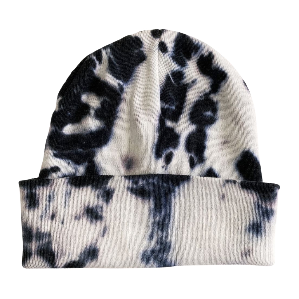 A knit beanie with a black and white tie-dye pattern, folded cuff, photographed against a plain background.