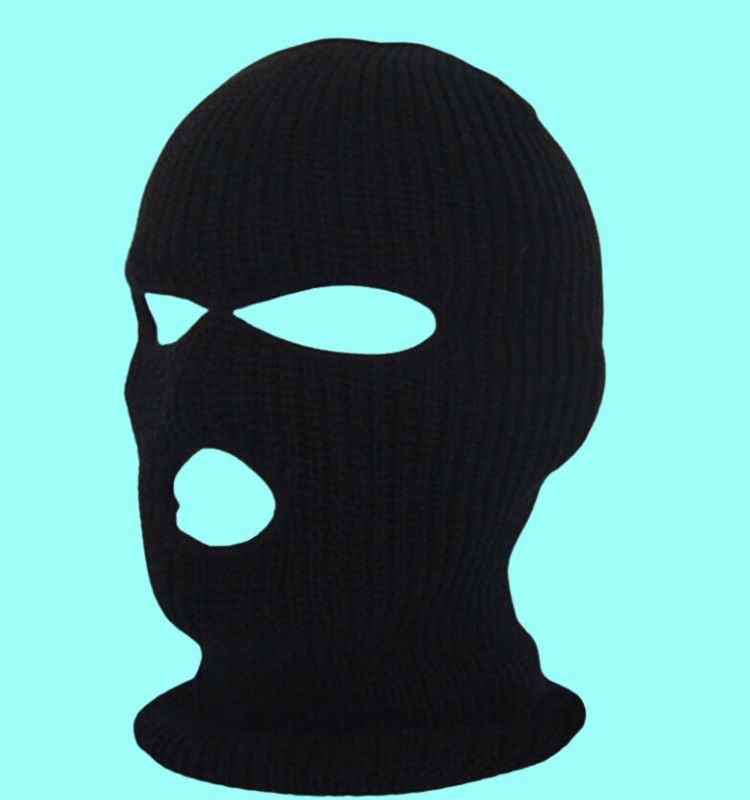 Black knitted custom ski mask with three holes for eyes and mouth on a blue background