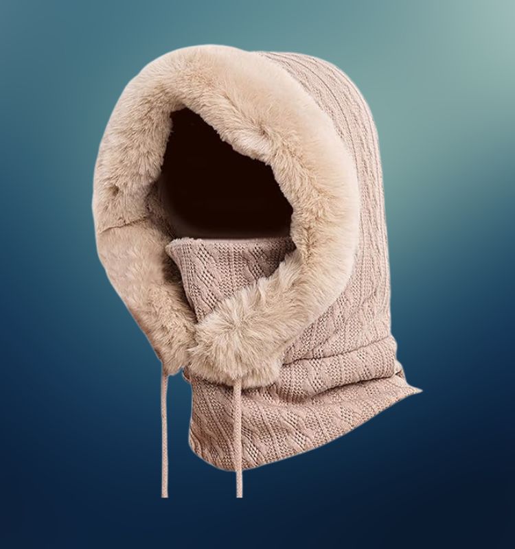 Beige faux fur-lined turtle balaclava with knitted design on blue gradient background.