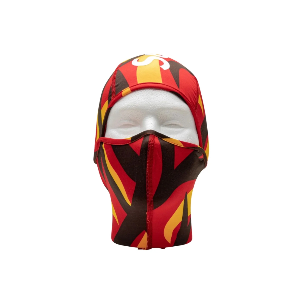 Red, yellow, and black patterned ski mask with bold flame-like design on a mannequin head.