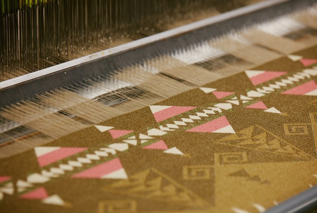 Close-up image of intricate Jacquard woven fabric showcasing detailed floral and geometric patterns, highlighting the complexity and craftsmanship of advanced weaving techniques.