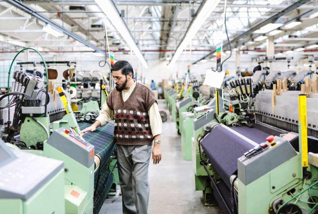 A vibrant textile manufacturing facility in Sialkot, showcasing workers and machinery producing textiles for global markets.