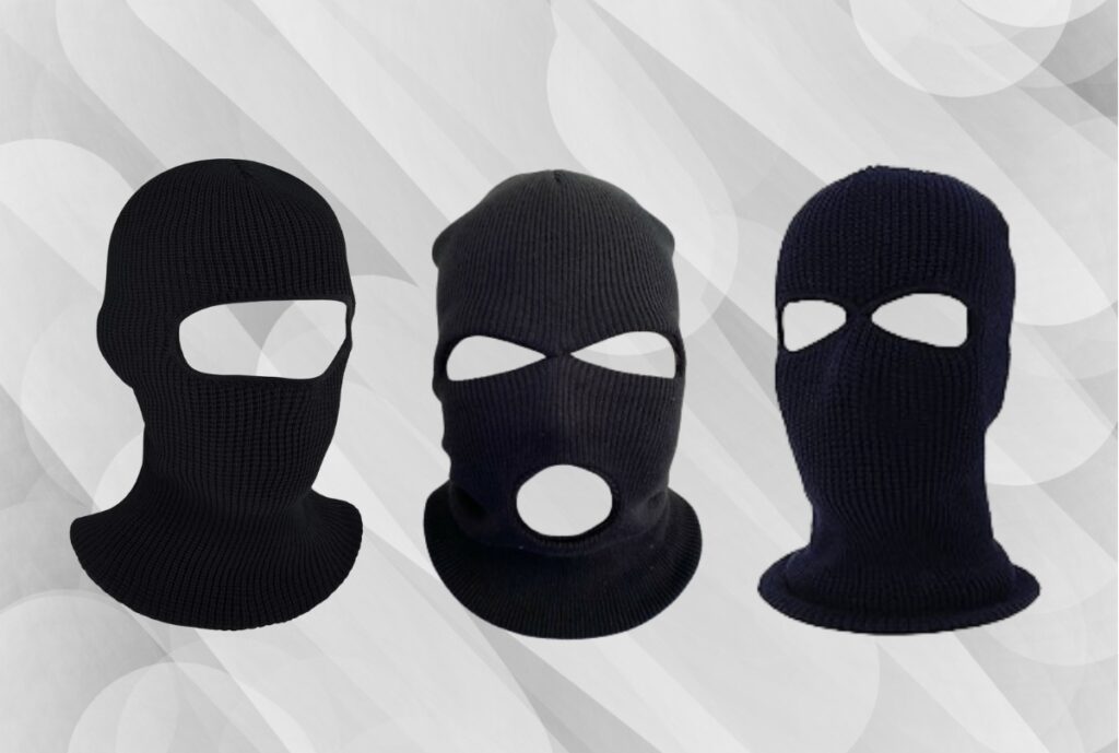 A close-up image of multiple black wholesale balaclavas stacked together, showing the fabric and design used for cold weather gear.