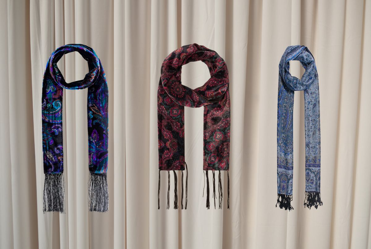 A luxurious burgundy velvet scarf with a soft, plush texture draped elegantly.