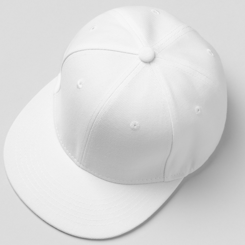 A clean white snapback cap with a six-panel crown and a curved brim, shown from a slight top-left angle to highlight its structured shape and stitching details.