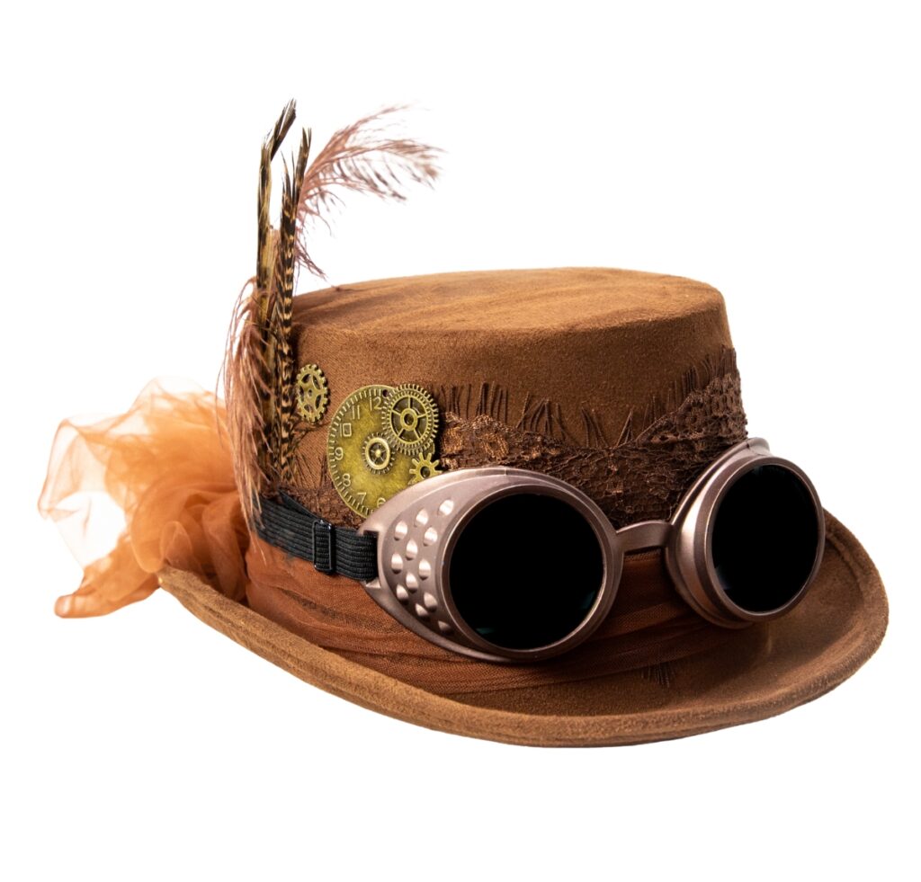 A brown suede top hat with steampunk embellishments: brass gears, lace trim, a black band, decorative feathers, and metallic goggles resting on the brim, set against a white background.