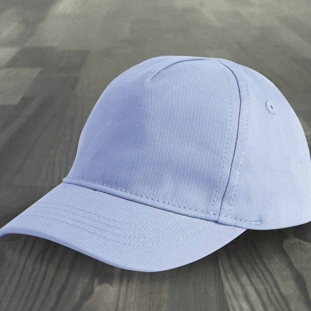 A light blue custom fitted baseball cap resting on a wooden surface, showing the front panel and curved brim.