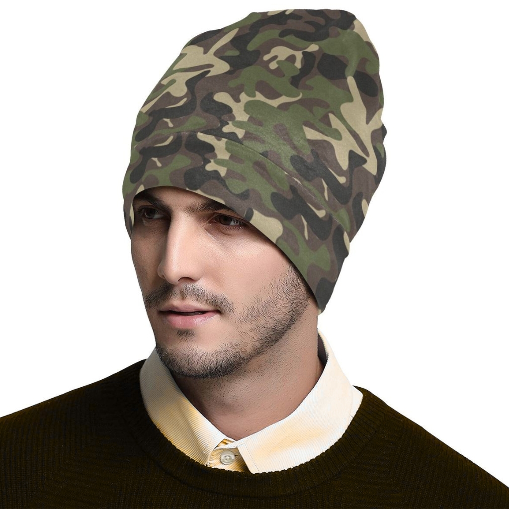 Model wearing a camouflage beanie hat in green, brown, and tan tones. Custom Camo Beanie Manufacturer