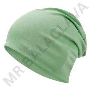 A soft, light green fall beanie hat folded at the edge.