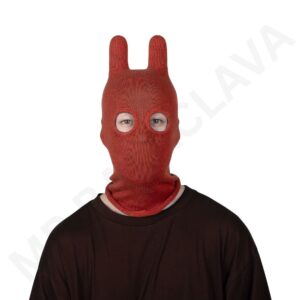 Person wearing a red knitted balaclava with two tall bunny-ear shapes and round eye openings.