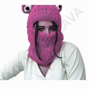 A person wearing a bright pink knitted balaclava that covers the head and neck, with a section over the mouth and a pair of eye openings, styled like a monster or animal face.