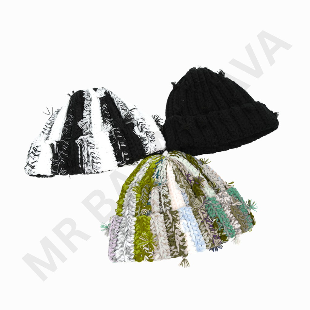 A trio of knitted beanies: a black beanie in the foreground, a black-and-white striped beanie in the middle, and a multicolored fringe-knit beanie in the background on a white backdrop.
