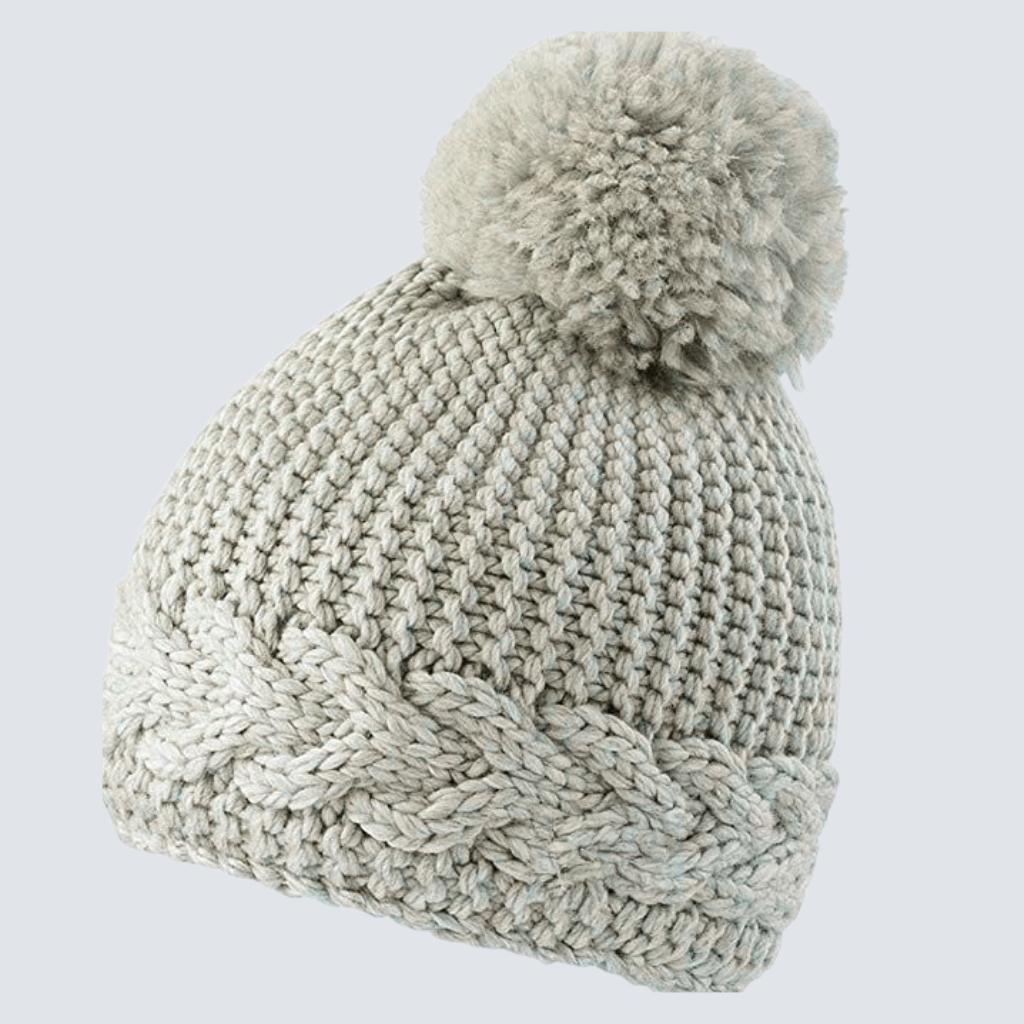 Close-up of a light gray crocheted beanie with a large fluffy pom-pom on top and a folded brim, showcasing chunky stitches. Custom Crochet Beanie Manufacturer