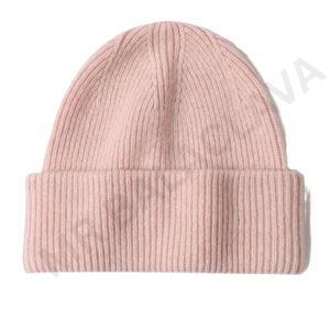 A light pink ribbed knit beanie hat on a white background.