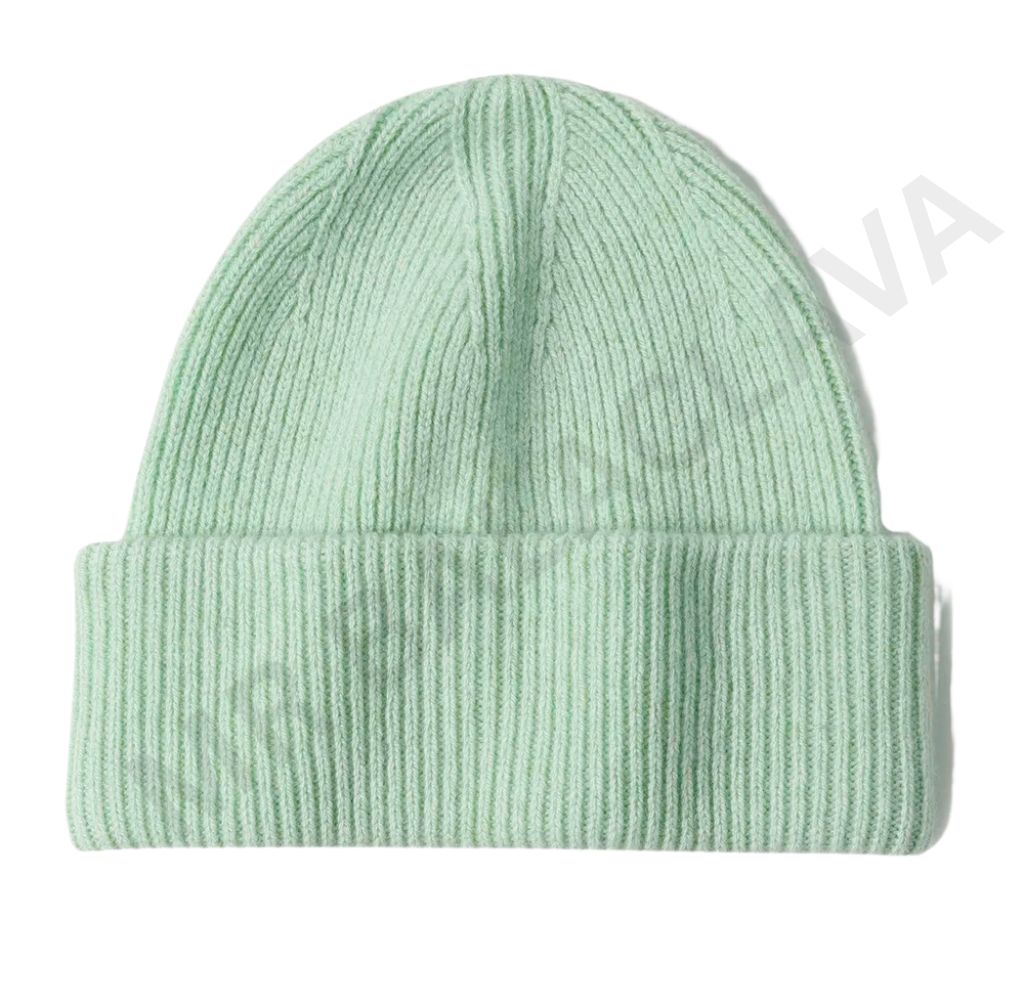 A light green ribbed knit beanie hat on a white background.