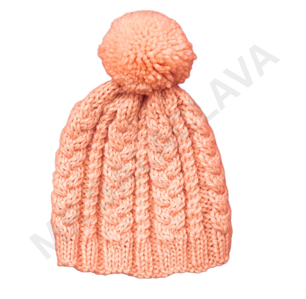 Peach-colored knit hat with a pom-pom and cable knit pattern