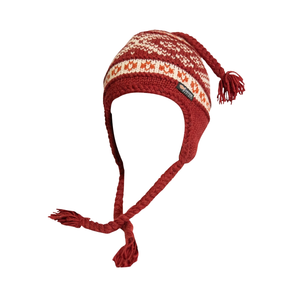 Gorro de invierno de punto rojo con orejeras y borlas trenzadas, con un estampado blanco y rojo y una pequeña etiqueta de la marca, sobre fondo blanco.