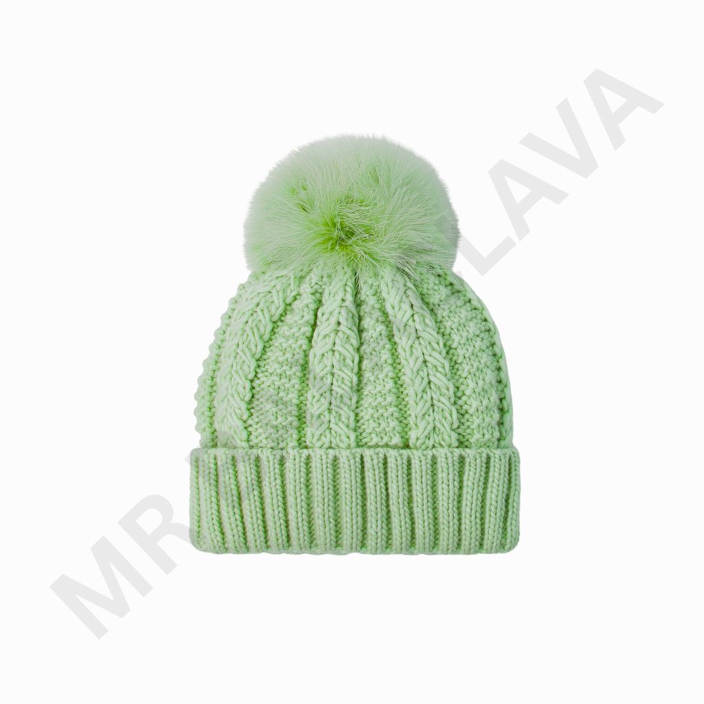 A soft mint green knitted beanie with a fluffy pom-pom on top and a ribbed cuff.