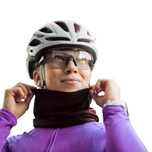 Person wearing a white helmet and purple jacket, pulling up a black ski neck gaiter over their neck.