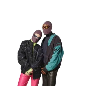 Two people wearing ski balaclavas and retro color-block jackets, posing together.