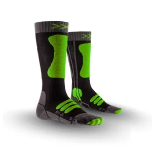 Pair of black ski socks with bright green accents, padded heel and toe areas, and gray reinforced sole; bold green sections along the shin and foot.