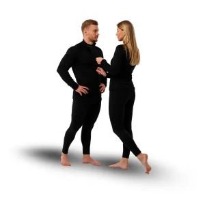 Two adults wearing black ski thermal base layers standing and facing each other, engaging in conversation.