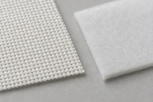 Cap Buckram & Foam Interlining: white cap buckram beside a piece of foam interlining