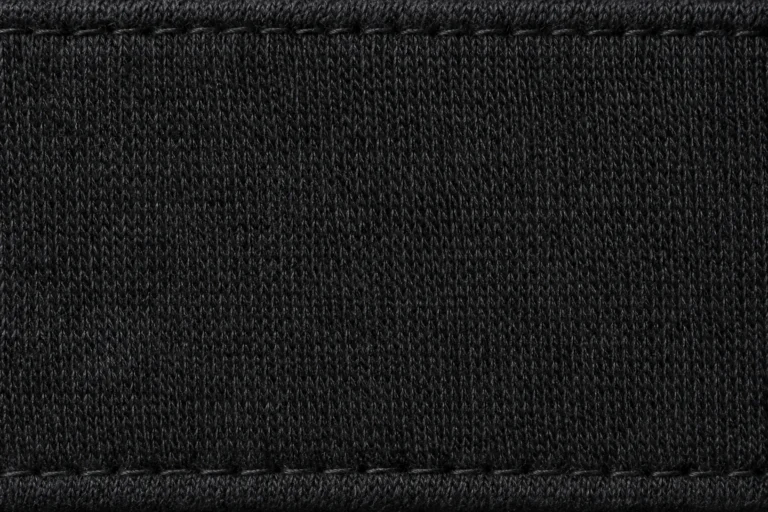 Cap Sweatband & Lining Fabrics: close-up of a black cap sweatband with a stitched edge