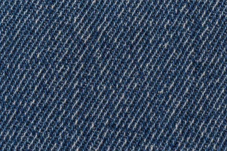 Denim (Cap Fabric): close-up of indigo denim twill with blue and white yarns
