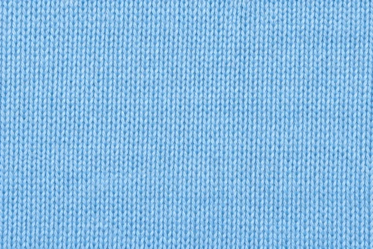 Close-up of sky-blue lightweight cotton jersey with fine knitted stitches