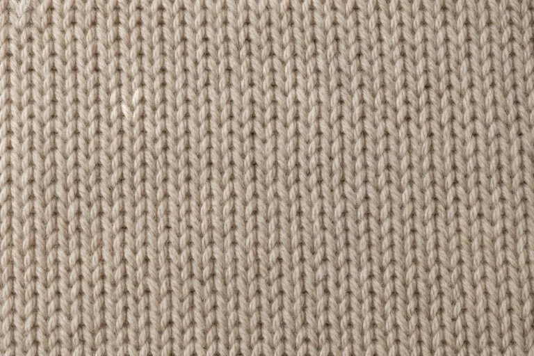 Merino & Wool Yarn Knit: close-up of oatmeal merino wool knit with clearly visible stitches