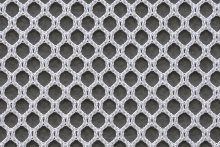 Polyester Cap Mesh: close-up of white polyester trucker-cap mesh with open holes