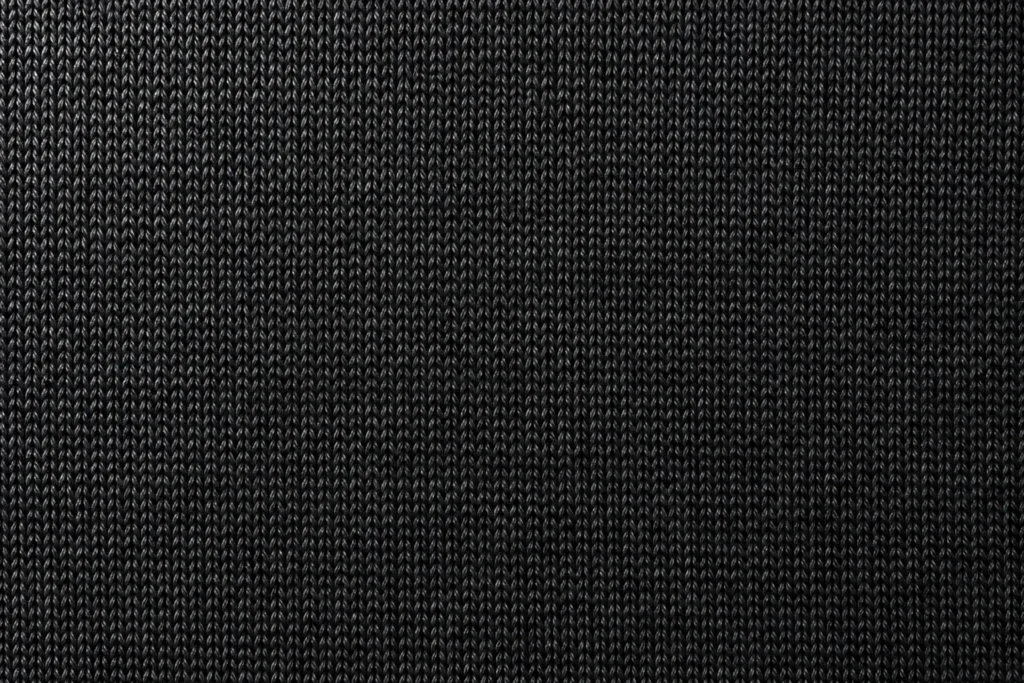 Close-up of black polyester-spandex stretch jersey with a soft sheen