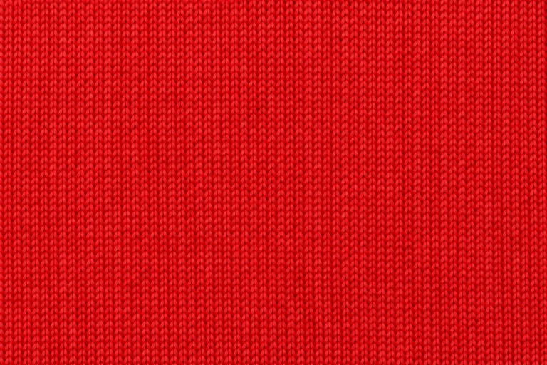 Close-up of bright-red polyester interlock with fine, even stitches