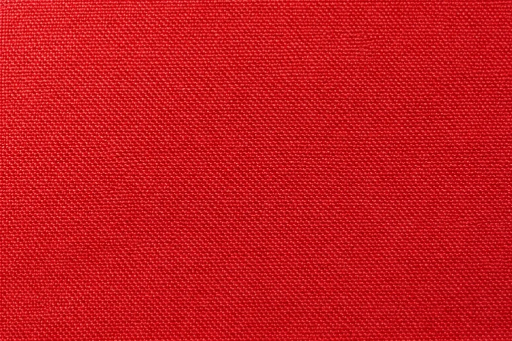 PU-Coated Waterproof Shell: close-up of red PU-coated shell fabric, woven face